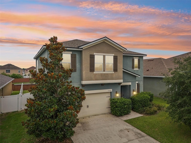 16440 Centipede St, Clermont, FL 34714 - view of front of home with stucco siding, an attached garage, concrete driveway, and a shingled roof