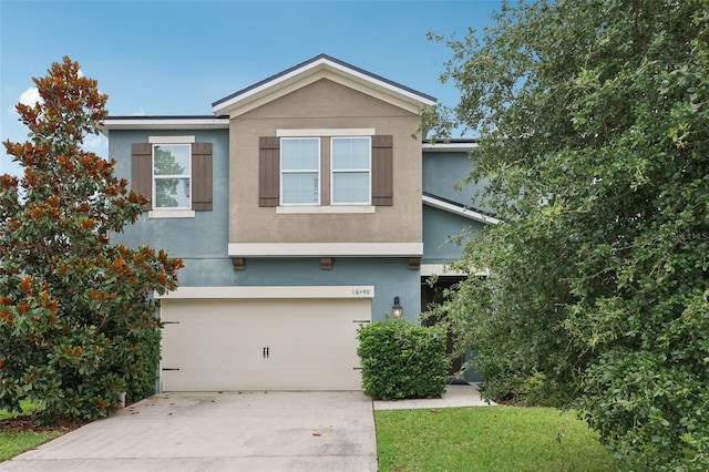 16440 Centipede St, Clermont, FL 34714 - view of front of property featuring stucco siding, a garage, and concrete driveway