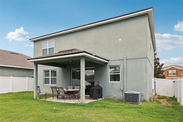 16440 Centipede St, Clermont, FL 34714 - rear view of house with stucco siding and a patio area