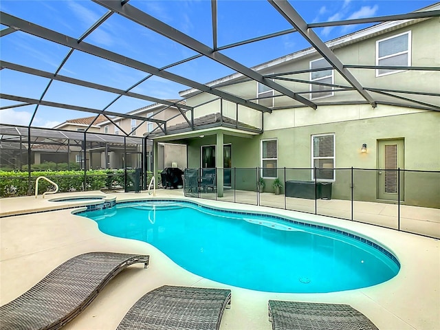 5255 Wildwood Way, Davenport, FL 33837 - view of pool with a patio area, a pool with connected hot tub, and glass enclosure