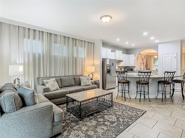 5255 Wildwood Way, Davenport, FL 33837 - living room with arched walkways, light tile patterned floors, and recessed lighting