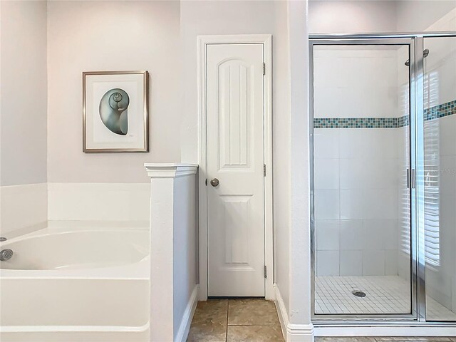 5255 Wildwood Way, Davenport, FL 33837 - bathroom with a shower stall, a garden tub, baseboards, and tile patterned floors