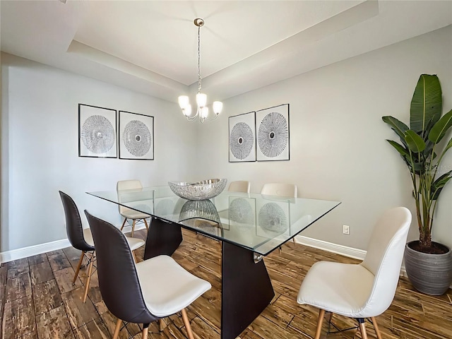 1540 Orange Valley Rdg, Ocoee, FL 34761 - dining room featuring baseboards, a tray ceiling, wood finished floors, and a chandelier