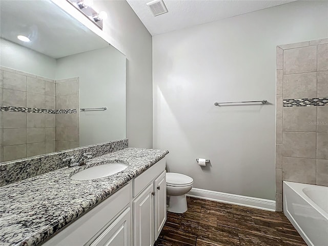 1540 Orange Valley Rdg, Ocoee, FL 34761 - bathroom featuring vanity, wood finished floors, toilet, baseboards, and tub / shower combination