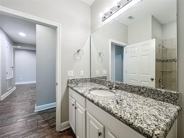 1540 Orange Valley Rdg, Ocoee, FL 34761 - bathroom with wood finished floors, a tile shower, vanity, and baseboards