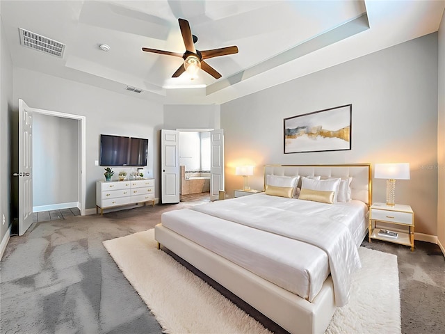 1540 Orange Valley Rdg, Ocoee, FL 34761 - bedroom with a raised ceiling, carpet floors, baseboards, ensuite bathroom, and ceiling fan