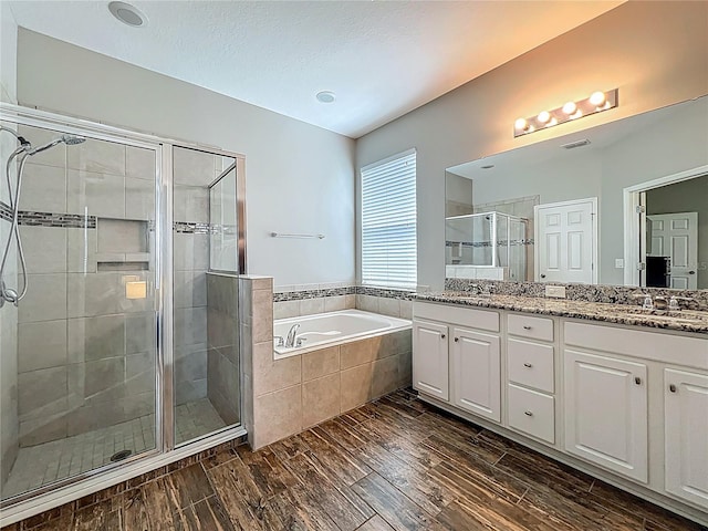 1540 Orange Valley Rdg, Ocoee, FL 34761 - full bath featuring a shower stall, a bath, double vanity, and wood finished floors