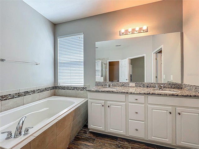1540 Orange Valley Rdg, Ocoee, FL 34761 - full bathroom featuring a garden tub, double vanity, an enclosed shower, and wood finished floors