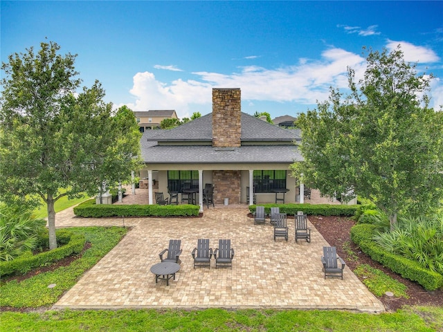1540 Orange Valley Rdg, Ocoee, FL 34761 - rear view of house with a patio, roof with shingles, and a chimney