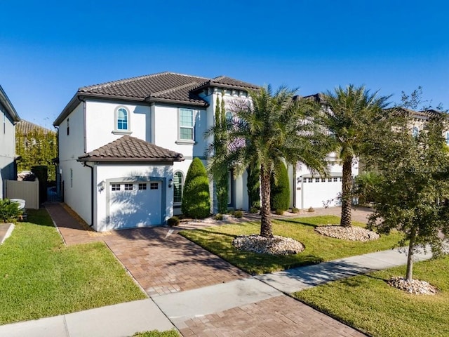 8085 Ludington Cir, Orlando, FL 32836 - mediterranean / spanish-style home featuring decorative driveway, stucco siding, and a tiled roof