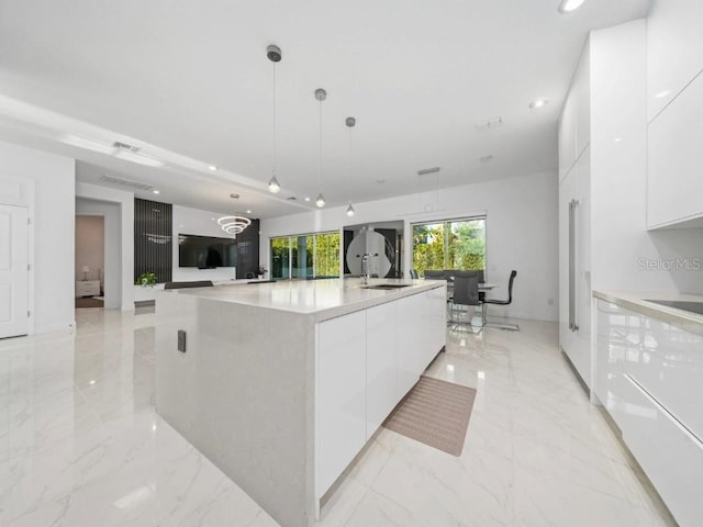8085 Ludington Cir, Orlando, FL 32836 - kitchen with modern cabinets, white cabinetry, recessed lighting, light marble finish floors, and hanging light fixtures