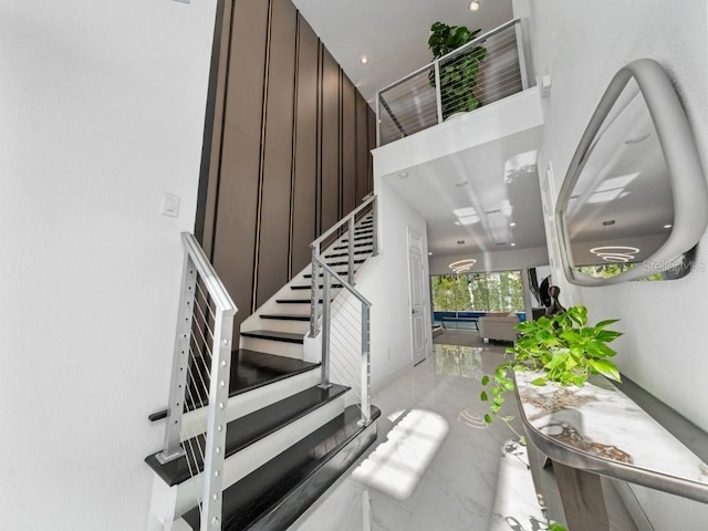 8085 Ludington Cir, Orlando, FL 32836 - staircase featuring marble tiled floors and a high ceiling