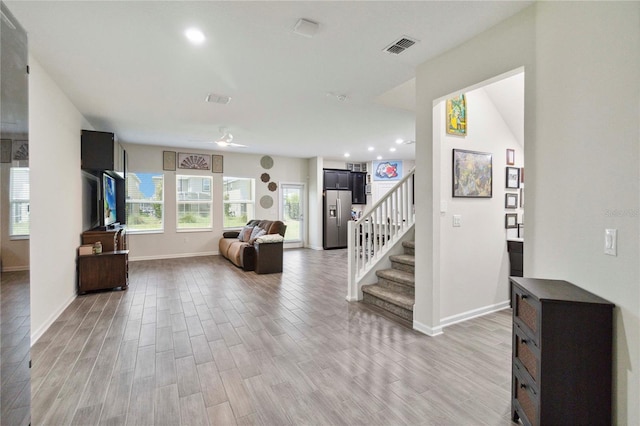 8975 Fluffy Lie Ct, Davenport, FL 33896 - entryway featuring light wood-style floors, stairway, and recessed lighting