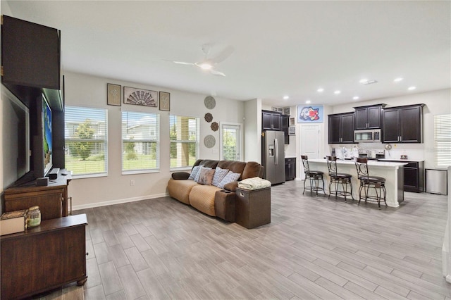 8975 Fluffy Lie Ct, Davenport, FL 33896 - living room with ceiling fan, light wood-style flooring, and recessed lighting