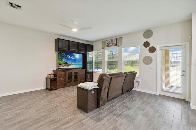 8975 Fluffy Lie Ct, Davenport, FL 33896 - living area with a ceiling fan and light wood-style flooring