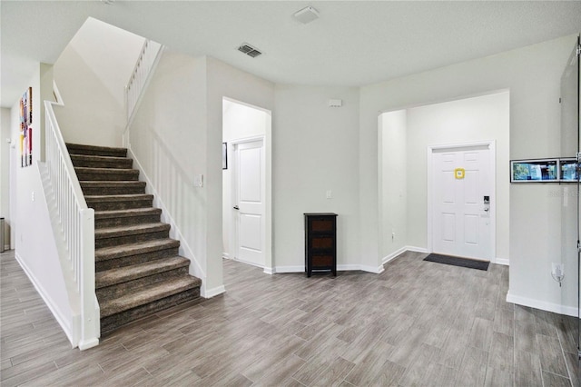 8975 Fluffy Lie Ct, Davenport, FL 33896 - foyer entrance featuring wood finished floors and stairway