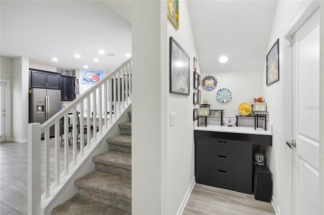 8975 Fluffy Lie Ct, Davenport, FL 33896 - stairway featuring wood finish floors and recessed lighting