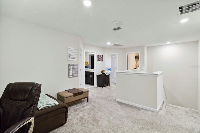 8975 Fluffy Lie Ct, Davenport, FL 33896 - sitting room featuring an upstairs landing, light colored carpet, and recessed lighting