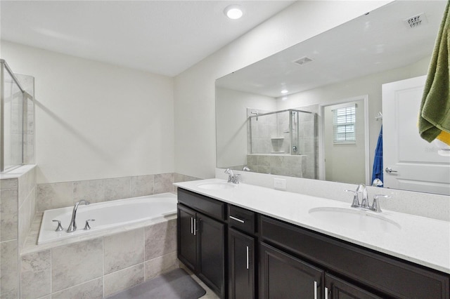 8975 Fluffy Lie Ct, Davenport, FL 33896 - full bathroom with a shower stall, a garden tub, and double vanity