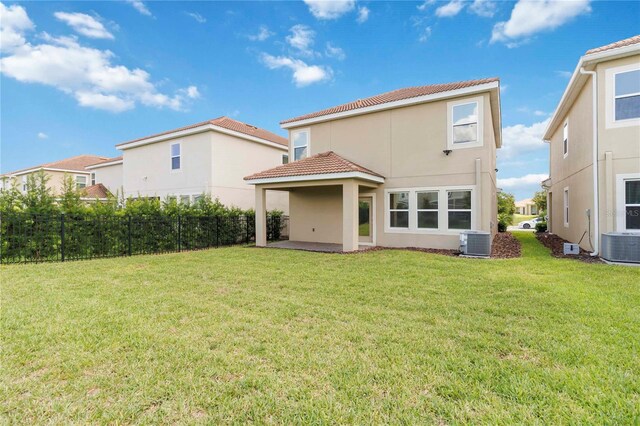 8975 Fluffy Lie Ct, Davenport, FL 33896 - back of house featuring a tiled roof, stucco siding, and a patio