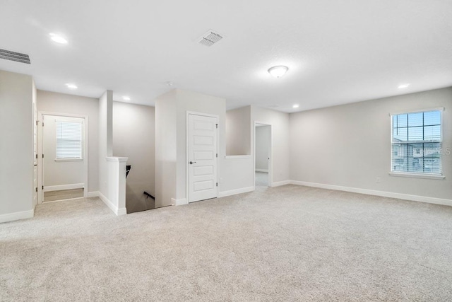 11063 Hollow Bay Dr, Winter Garden, FL 34787 - below grade area with light carpet, recessed lighting, and baseboards