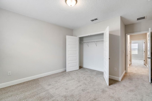 11063 Hollow Bay Dr, Winter Garden, FL 34787 - unfurnished bedroom with carpet floors, a textured ceiling, a closet, and baseboards