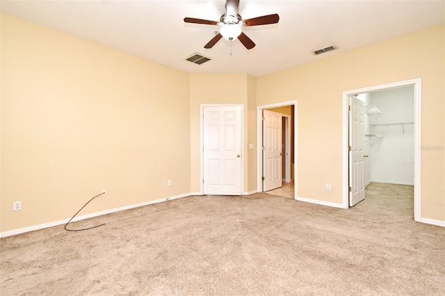 1086 Wickerwood St, Ocoee, FL 34761 - unfurnished bedroom with carpet floors, baseboards, a walk in closet, and a ceiling fan