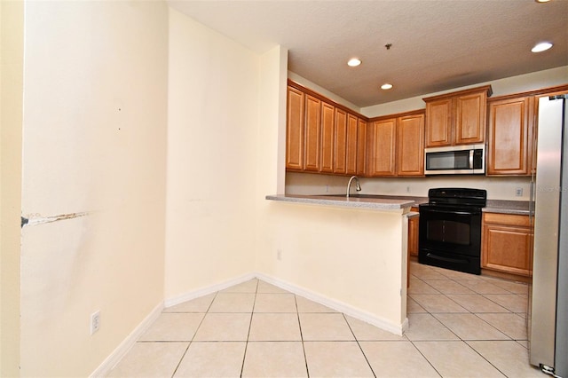 1086 Wickerwood St, Ocoee, FL 34761 - kitchen with stainless steel appliances, recessed lighting, light tile patterned floors, brown cabinetry, and light countertops