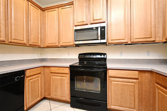 1086 Wickerwood St, Ocoee, FL 34761 - kitchen with black appliances, light tile patterned flooring, light countertops, and light brown cabinetry