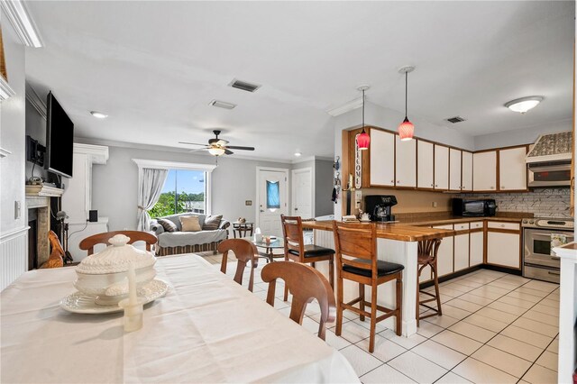 2112 Plymouth Sorrento Rd, Apopka, FL 32712 - kitchen featuring appliances with stainless steel finishes, light tile patterned floors, ornamental molding, open floor plan, and backsplash
