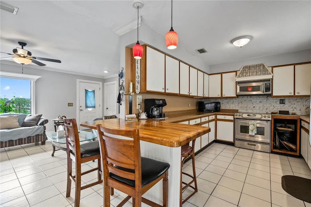 2112 Plymouth Sorrento Rd, Apopka, FL 32712 - kitchen with stainless steel appliances, light tile patterned flooring, a peninsula, backsplash, and a ceiling fan