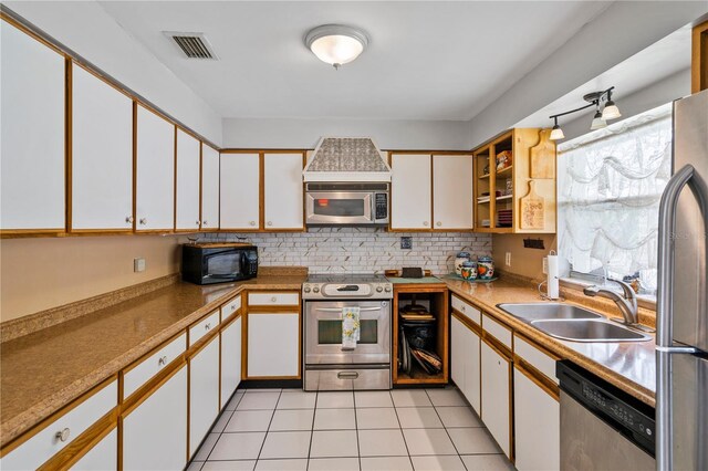 2112 Plymouth Sorrento Rd, Apopka, FL 32712 - kitchen featuring appliances with stainless steel finishes, a sink, white cabinetry, backsplash, and light tile patterned flooring