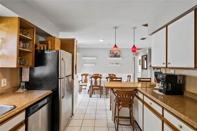 2112 Plymouth Sorrento Rd, Apopka, FL 32712 - kitchen with stainless steel dishwasher, light tile patterned floors, decorative light fixtures, white cabinetry, and open shelves