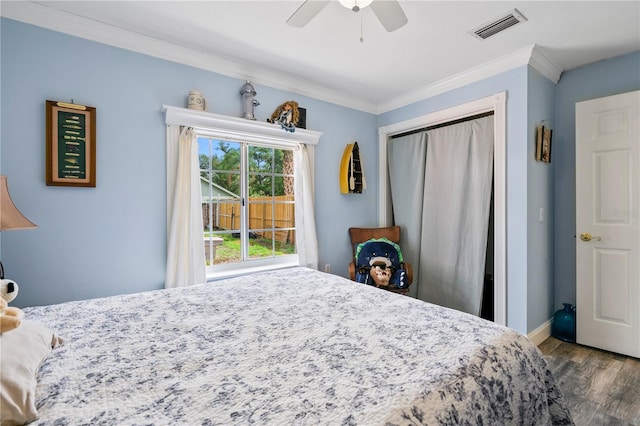 2112 Plymouth Sorrento Rd, Apopka, FL 32712 - bedroom with wood finished floors, crown molding, a closet, baseboards, and ceiling fan