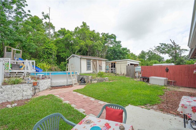 2112 Plymouth Sorrento Rd, Apopka, FL 32712 - view of yard with an outdoor structure, an outdoor pool, a patio area, and view of scattered trees