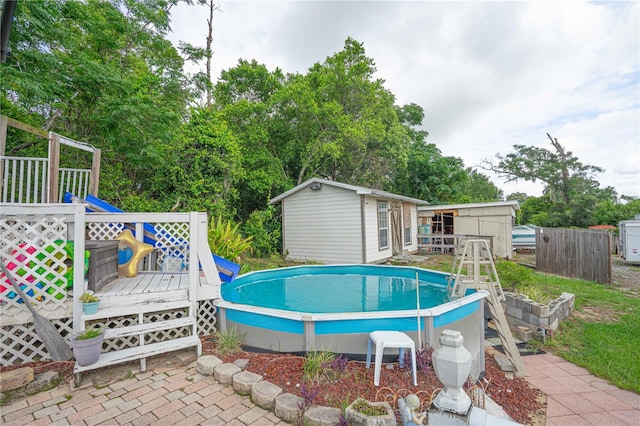 2112 Plymouth Sorrento Rd, Apopka, FL 32712 - swimming pool featuring a wooden deck, an outdoor structure, and view of wooded area