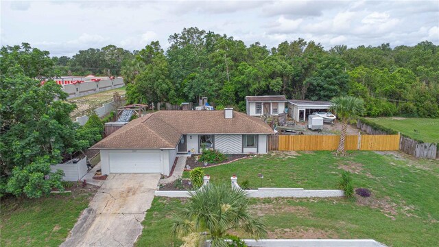 2112 Plymouth Sorrento Rd, Apopka, FL 32712 - ranch-style house with an attached garage, concrete driveway, and a view of trees