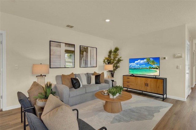 5608 Paddock Fence Ln, Apopka, FL 32712 - living room with wood finished floors, baseboards, and recessed lighting