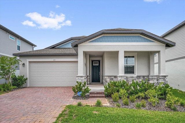 2311 Bear Peak Rd, Clermont, FL 34715 - view of front of home featuring stucco siding, a garage, decorative driveway, stone siding, and a porch