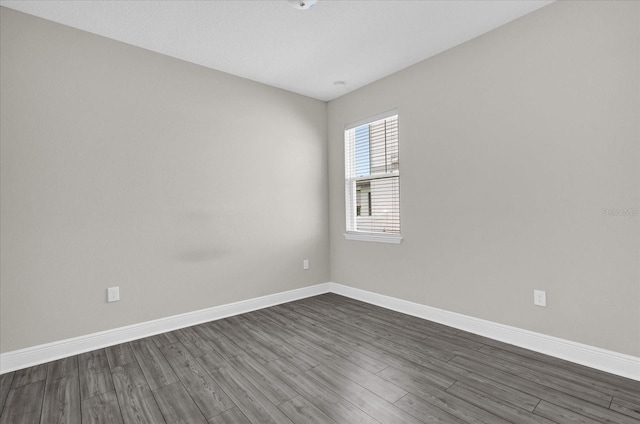 2311 Bear Peak Rd, Clermont, FL 34715 - spare room featuring dark wood finished floors and baseboards