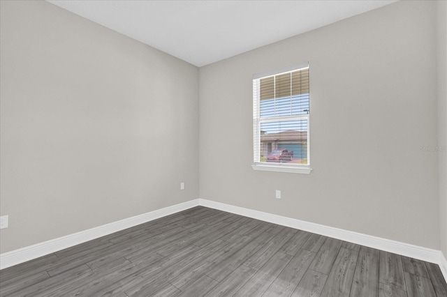 2311 Bear Peak Rd, Clermont, FL 34715 - empty room with dark wood-style flooring and baseboards