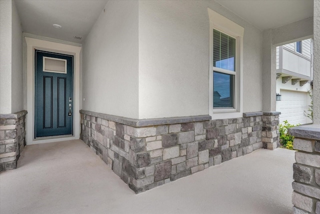 2311 Bear Peak Rd, Clermont, FL 34715 - view of exterior entry featuring stucco siding and stone siding