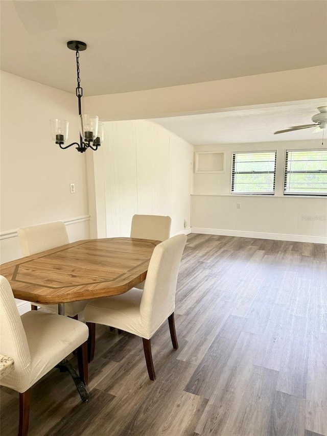 10301 US Highway 27 Unit 34, Clermont, FL 34711 - dining room with dark wood-style floors, a ceiling fan, a chandelier, and baseboards