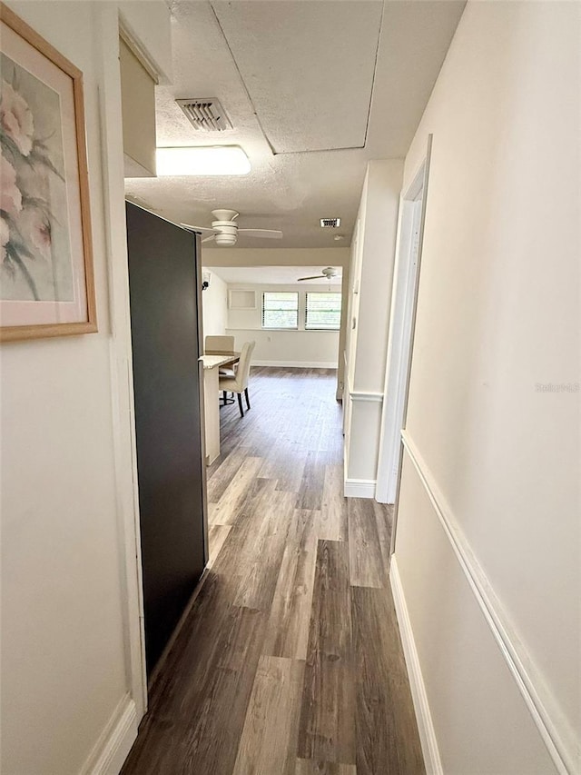 10301 US Highway 27 Unit 34, Clermont, FL 34711 - hall with dark wood-type flooring, baseboards, a textured ceiling, and attic access