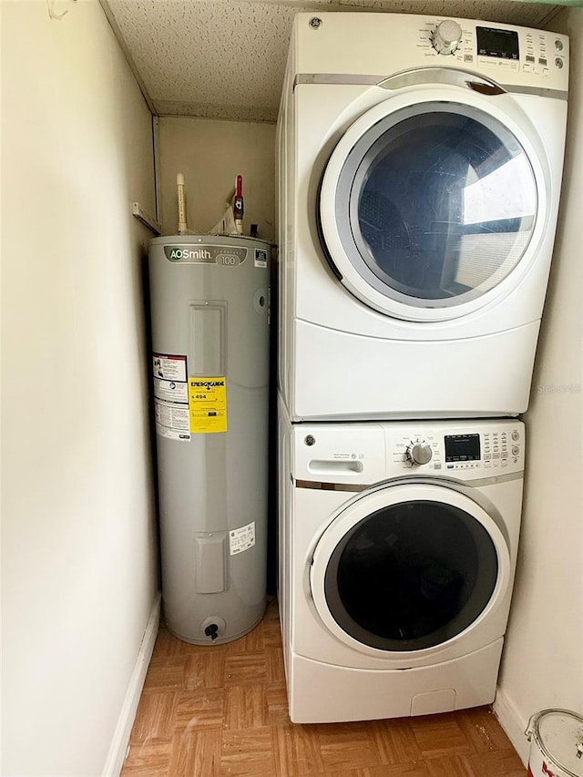 10301 US Highway 27 Unit 34, Clermont, FL 34711 - laundry area featuring water heater, stacked washer / drying machine, and baseboards