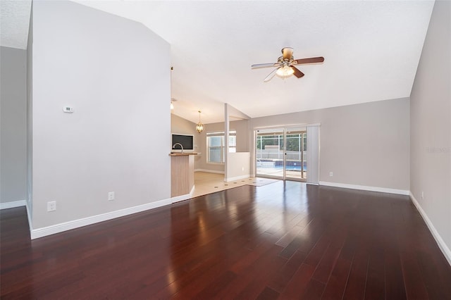 1115 Marni Ridge Ct, Kissimmee, FL 34747 - unfurnished living room featuring vaulted ceiling, a ceiling fan, wood finished floors, and baseboards