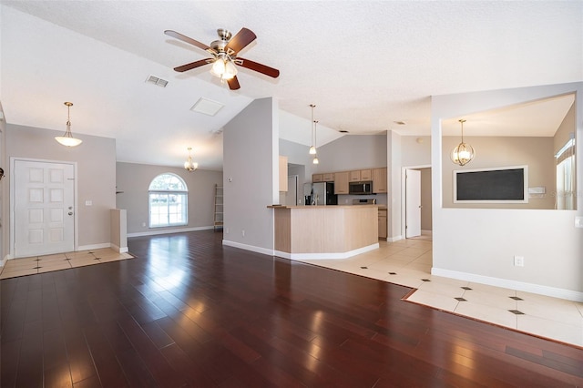 1115 Marni Ridge Ct, Kissimmee, FL 34747 - unfurnished living room featuring lofted ceiling, light wood-style flooring, ceiling fan, and baseboards