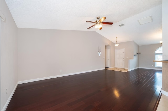 1115 Marni Ridge Ct, Kissimmee, FL 34747 - unfurnished living room featuring a ceiling fan, vaulted ceiling, wood finished floors, baseboards, and a textured ceiling