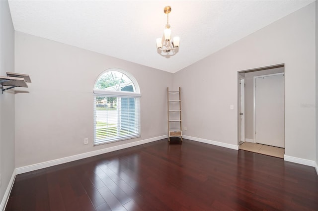 1115 Marni Ridge Ct, Kissimmee, FL 34747 - unfurnished room with a chandelier, wood finished floors, vaulted ceiling, and baseboards