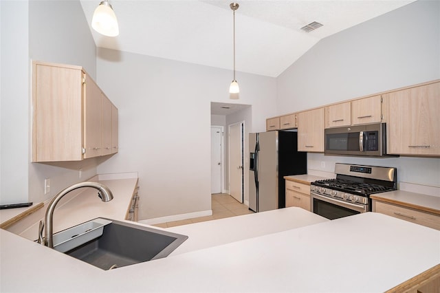 1115 Marni Ridge Ct, Kissimmee, FL 34747 - kitchen featuring appliances with stainless steel finishes, light brown cabinetry, a sink, light countertops, and decorative light fixtures